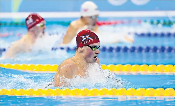  ??  ?? In the zone: Great Britain’s Adam Peaty broke his own world record by 0.37 sec