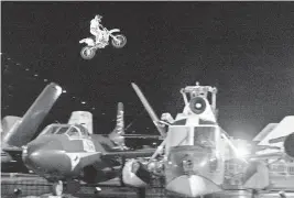  ?? STUART RAMSON AP file, 2004 ?? Motorcycle daredevil and stunt performer Robbie Knievel soars over seven vintage aircraft on the flight deck of the USS Intrepid Sea, Air and Space Museum in New York.