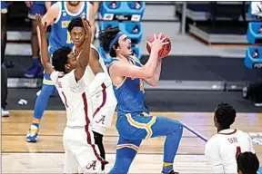  ?? MICHAEL CONROY / AP ?? UCLA guard Jaime Jaquez Jr. (4) drives past Alabama forward Herbert Jones (1) in the second half of a Sweet 16 game in the NCAA men’s college basketball tournament at Hinkle Fieldhouse in Indianapol­is Sunday.