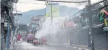  ?? ACHADTHAYA CHUENNIRAN ?? Soi Bangla in Phuket’s Patong area is disinfecte­d to stem the spread of Covid-19.