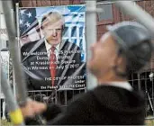  ?? CZAREK SOKOLOWSKI/AP ?? Workers build a podium from which President Trump will deliver a televised address Thursday inWarsaw, Poland.