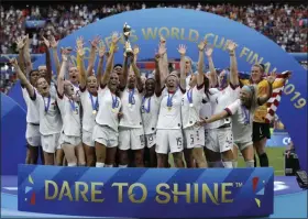  ?? ALESSANDRA TARANTINO - THE ASSOCIATED PRESS ?? FILE - In this July 7, 2019 file photo United States’ team celebrates with the trophy after winning the Women’s World Cup final soccer match between US and The Netherland­s at the Stade de Lyon in Decines, outside Lyon, France.