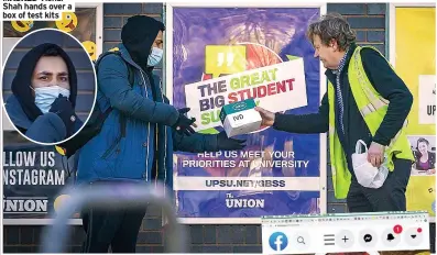  ?? PICTURE: ADAM GERRARD ?? MASKED Vishal Shah hands over a box of test kits