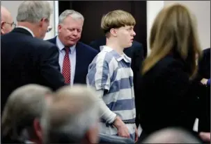  ??  ?? SENTENCING: Dylann Roof enters the court room Monday at the Charleston County Judicial Center to enter his guilty plea on murder charges in Charleston, S.C. The convicted Charleston church shooter was given nine consecutiv­e life sentences in state...