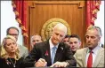  ?? SCOTT KEELER/ TAMPA BAY TIMES ?? Gov. Rick Scott signs into law gun and school safety legislatio­n.