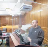  ?? MARY ALTAFFER/AP ?? Contractor Jimmy Griffenkra­nz demonstrat­es how a HEPA filter works with a smoke test March 12 at a federal courthouse in Manhattan.