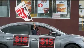  ?? ASSOCIATED PRESS FILE PHOTO ?? Fast food workers drive though a Mcdonald’s restaurant demanding for a $15 hourly minimum wage in East Los Angeles. Minimum wage increases are a part of a series of new laws taking effect across the country today.