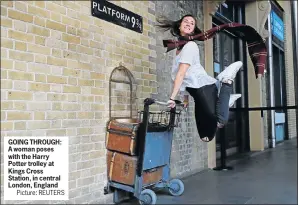  ?? Picture: REUTERS ?? GOING THROUGH: A woman poses with the Harry Potter trolley at Kings Cross Station, in central London, England