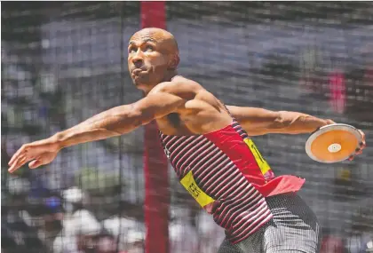  ?? DAVID J. PHILLIP/THE ASSOCIATED PRESS ?? Damian Warner of London, Ont., prepares to throw the discus Thursday as part of the Olympic decathlon. Warner set a Games record with 9,018 points earned in the 10 events. Only three other athletes have ever cracked the 9,000-point barrier.