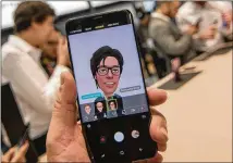  ?? ROBERT MARQUARDT / GETTY IMAGES ?? Attendees at the Mobile World Congress 2018, which was held in Barcelona, Spain, last month, use the Samsung Galaxy S9’s AR Emoji program. The S9 was available Friday.