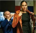  ?? JESSICA HILL / ASSOCIATED PRESS ?? Rebecca Lobo adjusts her Hall of Fame jacket with Hall President John Doleva’s help during a news conference Thursday.