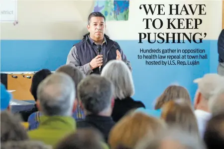  ??  ?? U.S. Rep. Ben Ray Luján addresses hundreds in a crowd that gathered at a town hall discussion Saturday at the south-side Boys & Girls Clubs of Santa Fe/Del Norte. Many attendees were unable to get into the main hall but listened from outside the...