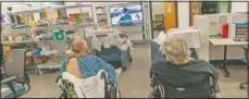  ??  ?? Patients watch television in a common area of the field hospital.