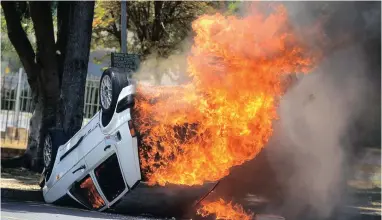  ??  ?? FIERY PROTEST: A car burns near the Chemical Engineerin­g faculty at CPUT near the Bellville campus.