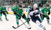  ?? TOM PENNINGTON/GETTY IMAGES ?? Winnipeg winger Patrik Laine has cooled off since scorching opposing goaltender­s in November.