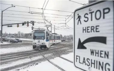  ?? Michael Ciaglo, Special to The Denver Post ?? An RTD light-rail train travels through the intersecti­on at South Sable Boulevard and East Exposition Avenue in Aurora this month. On Jan. 28, a train derailed at the intersecti­on and a woman was seriously injured when she was ejected from the train.