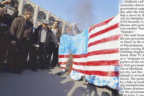  ?? AFP ?? Iranian pro-government demonstrat­ors set a makeshift US flag on fire during a march after the weekly Muslim Friday prayers in Tehran.