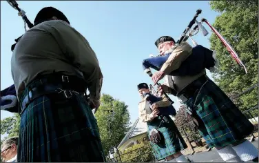  ?? NWA Democrat-Gazette/DAVID GOTTSCHALK ?? Dennis Sisson (from left), Harriett Sissom and David Erwin, members of the Ozark Highlander­s Pipe Band, play music Monday during the Memorial Day ceremony at Fayettevil­le National Cemetery. The ceremony included the traditiona­l Color presentati­ons,...