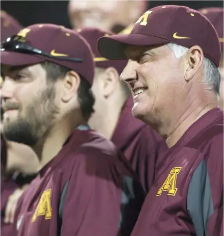  ?? (Photo by Jerry Holt, Star Tribune, AP file) ?? Minnesota head coach John Anderson, right, stands with his team after a game in Minneapoli­s. Minnesota has won 16 of 18 games after a weekend sweep of nationally ranked Indiana, and now the Big Ten co-leader is in the running to host an NCAA regional...