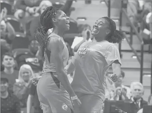  ?? JESSICA HILL/AP ?? Connecticu­t Sun’s Bria Holmes and teammate Morgan Tuck celebrate during the second half of a WNBA playoff game on Sept. 19 in Uncasville.