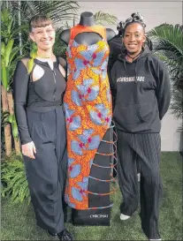  ?? AP PHOTO ?? Becca Mccharen-tran (left) the founder of Chromat, stands with Chromat designer Tolu Aremu and a dress they created for a small collection inspired by the film ‚“Black Panther” Monday in New York.