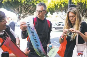  ?? Nicole Boliaux / The Chronicle ?? Adam Werbach (center), co-founder of Win the Future, works with organizer Jessica Tully (left) and project manager Danielle Guerin outside the Armed Forces Recruiting Center in S.F.