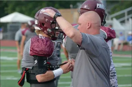  ?? MORNING JOURNAL FILE ?? Rocky River assistant coach Sean Ranc, right, gives his brother Josh a hug prior to a game.