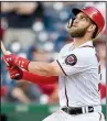  ??  ?? AP/NICK WASSBryce Harper of the Washington Nationals watches his 10th inning sacrifice fly that allowed pinch-runner Michael Taylor to score the winning run in a 4-3 victory over the St. Louis Cardinals on Monday in Washington.