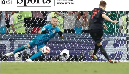  ??  ?? CROATIA’s midfielder Ivan Rakitic (R) scores his penalty past Russia’s goalkeeper Igor Akinfeev during the Russia 2018 World Cup quarterfin­al football match between Russia and Croatia at the Fisht Stadium in Sochi on July 7.