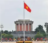  ?? AFP ?? A Vietnamese flag flutters above the Ho Chi Minh mausoleum in Hanoi.