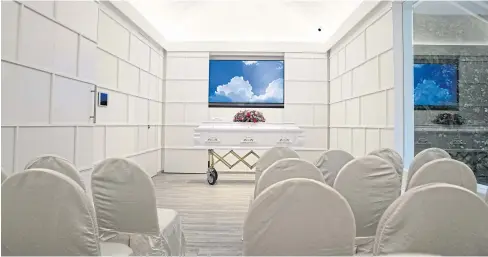  ??  ?? ABOVE
Chairs and a casket is seen inside a room at Flying Home.