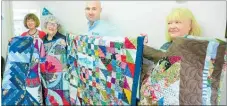  ?? Photo / Rachel Canning ?? Tongariro Prison director Scott Walker presents four hand-made quilts to Age Concern Taupo¯ staff (from left) Lyndsay Bennefield, Val Hoogerbrug­ge (chairwoman) and Ann Blackler. The quilts were made by inmates at Tongariro Prison as part of a new volunteer programme involving Taupo¯ Quiltmaker­s.