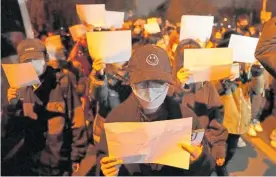  ?? Photo / AP ?? Protesters hold up blank pieces of paper and call for the resignatio­n of President Xi Jinping.