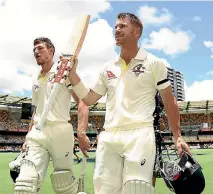  ?? RYAN PIERSE/GETTY IMAGES ?? Cameron Bancroft, left, and David Warner salute the crowd after their unbeaten second innings partnershi­p delivered Australia the first Ashes test against England at the Gabba.