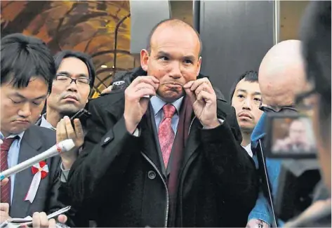  ?? Shuji Kajiyama / AP Photo ?? The former chief executive of Olympus, Michael Woodford, who blew the whistle on dubious spending at the company, speaks to reporters in Tokyo yesterday. He says he is giving up his fight to regain the leadership of the camera maker.