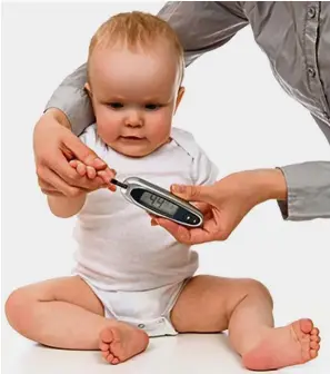  ??  ?? A mother measures her baby’s blood glucose levels. Obesity’s upward trend means that the rates of diabetes, hypertensi­on and chronic kidney disease will follow closely.