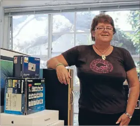  ?? Photo: JESS ETHERIDGE ?? Starting over: Auckland Festival of Photograph­y founder Julia Durkin in the charity’s office which was burgled twice last year. The empty boxes represent more than $8000 of equipment that was taken.