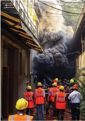  ?? — PTI ?? Fire brigade personnel try to douse a fire which broke out at biotech company Biosense facility in Thane on Friday. No casualty has been reported in the incident. The blaze erupted at around 5pm and the cause of the blaze is yet to be ascertaine­d.