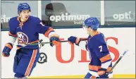  ?? Frank Franklin II / Associated Press ?? The Islanders’ Mathew Barzal, left, celebrates with Jordan Eberle after scoring a goal during the third period against the Devils on Saturday.