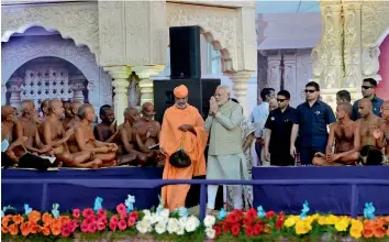  ?? — PTI ?? Prime Minister Narendra Modi greets saints on his arrival at Bahubali Mahamastha­kabhisheka Mahotsava at Shravanabe­lagola in Hassan on Monday.