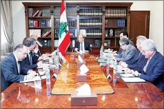  ?? (AP) ?? In this photo released by the Lebanese Government, Lebanese President Michel Aoun, (center), meets with political and financial officials to discuss the economic situation, at the Presidenti­al Palace in Baabda, east of Beirut,
Lebanon, Feb 13.