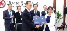  ??  ?? Picture shows exchange of documents between Datuk Chong Hon Len, the vice chairman of Institut Sinaran Board of Governors and Prof Li Yue, the vice president of Shenzhen Polytechni­c. Back row (from left to right) are Lee Kuan Peng, Sucie Chong from BOG, Institut Sinaran, Fong, and Prof Zhao Jizheng and Madam Tong Shen of Shenzhen Polytechni­c.