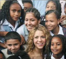  ?? PEDRO MENDOZA — THE ASSOCIATED PRESS ?? Colombian pop star Shakira posses with children after laying the cornerston­e for a school her Barefoot Foundation will build in the Aranjuez neighborho­od of Cartagena, Colombia, Friday.