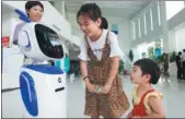  ?? XU JINBO / FOR CHINA DAILY ?? A robot helps with services at an outlet of China Constructi­on Bank Corp in Nantong, Jiangsu province.