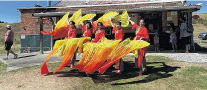  ?? PHOTO: ODT FILES ?? Grace and joy . . . The Dunedin Culture & Arts Associatio­n performs a dance in front of the historic Chinese Empire Hotel at last year’s Chinese New Year celebratio­ns at Lawrence Chinese Camp.