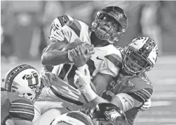  ?? RICK BOWMER/ AP ?? Utah defensive end Maxs Tupai, right, tackles Arizona quarterbac­k Jamarye Joiner (10) during the first half Friday in Salt Lake City.