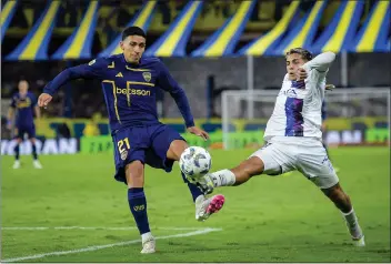  ?? MARCELO ENDELLI — GETTY IMAGES, FILE ?? Ezequiel Fernandez of Boca Juniors competes for the ball with Hernan Lopez Muñoz of Godoy Cruz during a group B match between Boca Juniors and Godoy Cruz at Estadio Alberto J. Armando on April 16in Buenos Aires, Argentina.