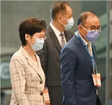  ??  ?? Lam (left) leaves the convention and exhibition centre in Hong Kong.