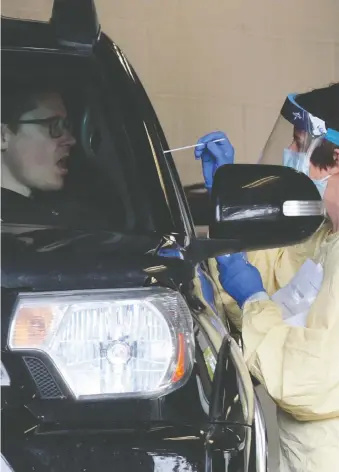  ?? GAVIN YOUNG ?? A driver is tested for COVID-19 in one of the drive-thru testing centres at the Richmond Road Diagnostic and Treatment Centre on Thursday. Alberta’s death toll from the virus sits at 160.