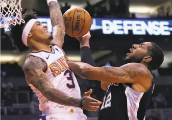  ?? Rick Scuteri / Associated Press ?? Kelly Oubre Jr. ( left) averaged 18.7 points per game last season even though Phoenix Suns coach Monty Williams said he didn’t run many plays for him: “He brings an edge every night.”